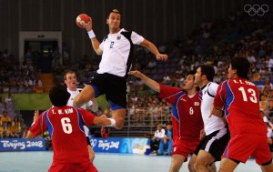 BEIJING - AUGUST 10: Pascal Hens (#2) of Germany rises above the defence to shoot at goal during the Men's Handball Preliminaries Group B match between Germany and South Korea held at the Olympic Sports Center Gymnasium during Day 2 of the Beijing 2008 Olympic Games on August 10, 2008 in Beijing, China. Germany went to win the match 27-23.  (Photo by Michael Steele/Getty Images)